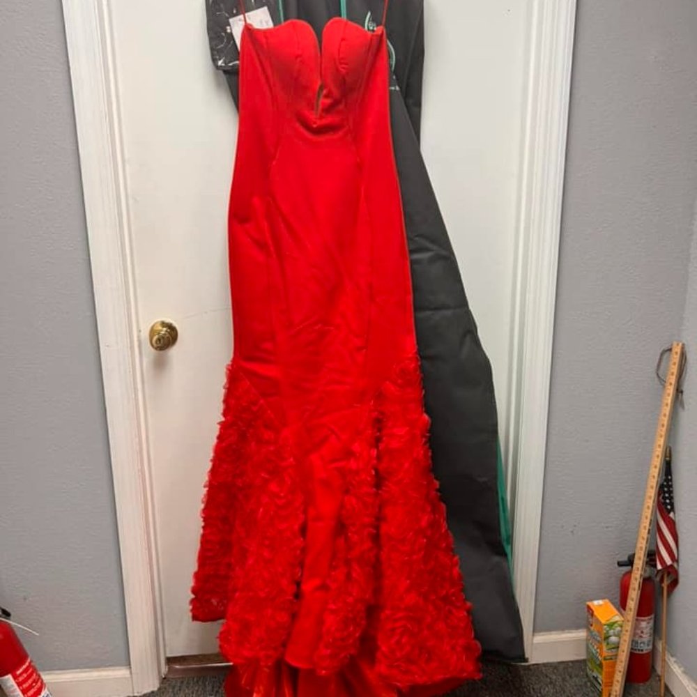 Strapless, red prom gown. Has a mesh section at the dip of the top for coverage